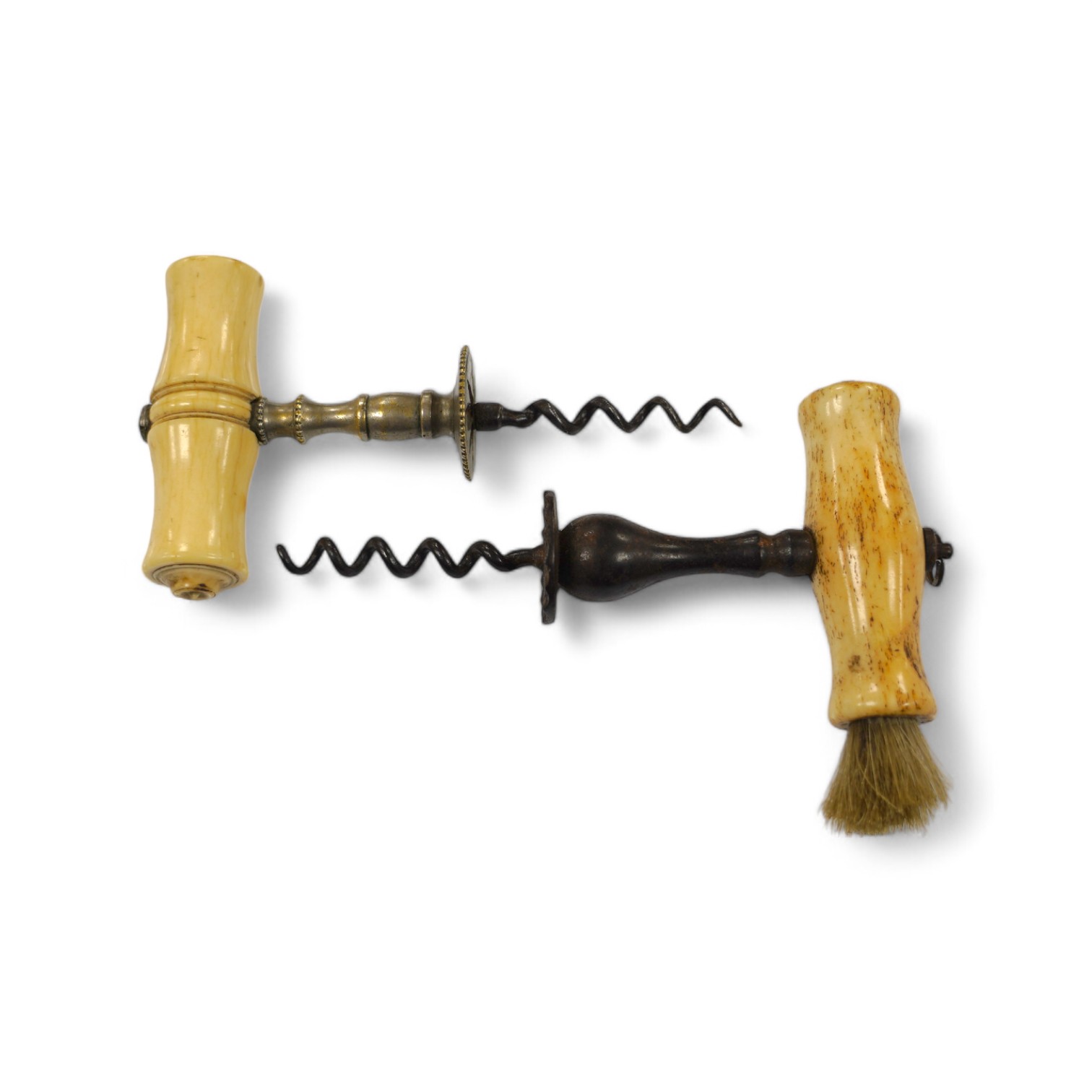 Two early 19th century bone handled corkscrews, one in steel with brush, the other in brass. Condition - good, brass example was silvered, small vacant hole to one end of the handle, no loop or ring